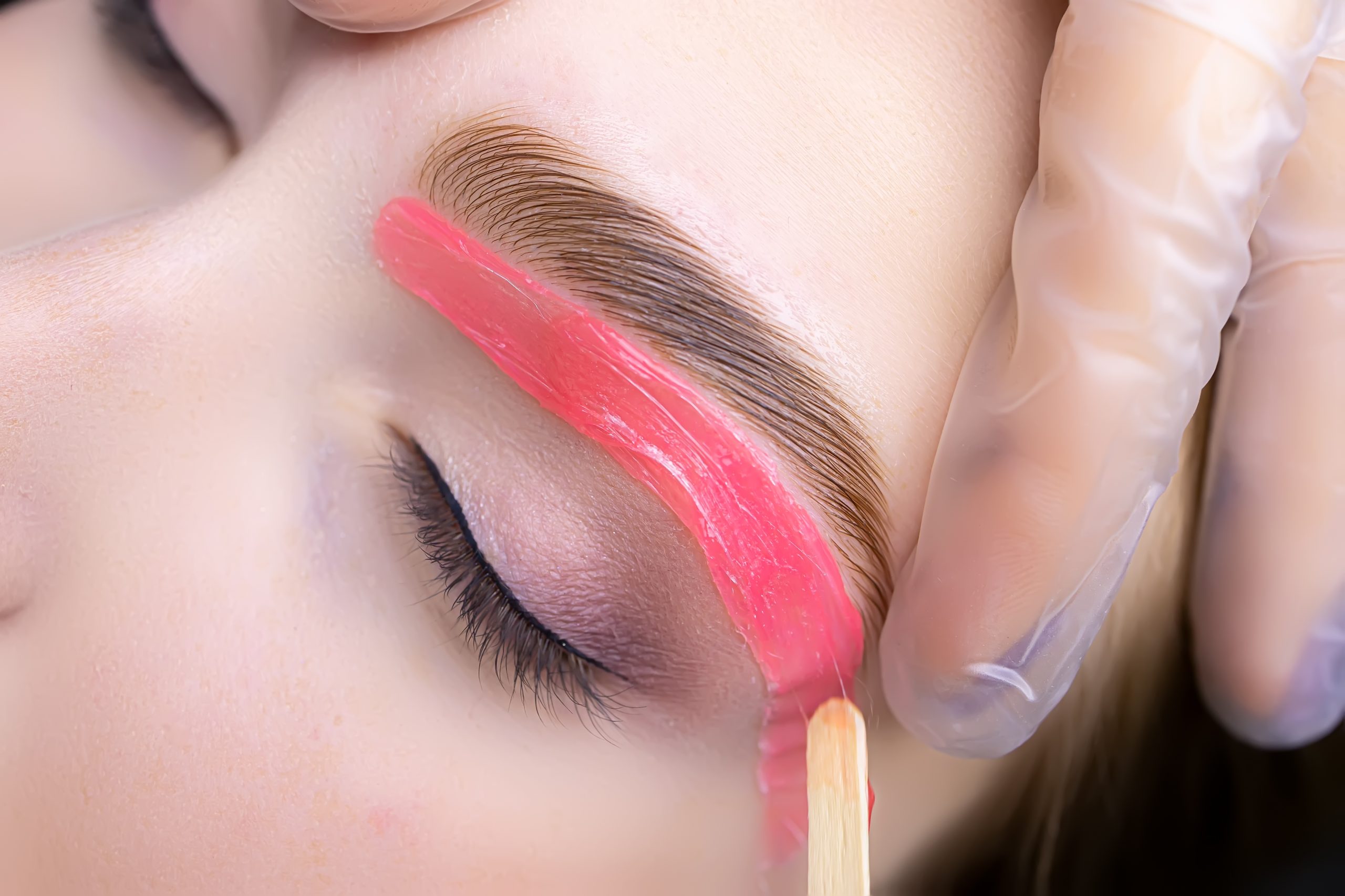 close-up of the applied wax on the lower contour of the skin under the eyebrows